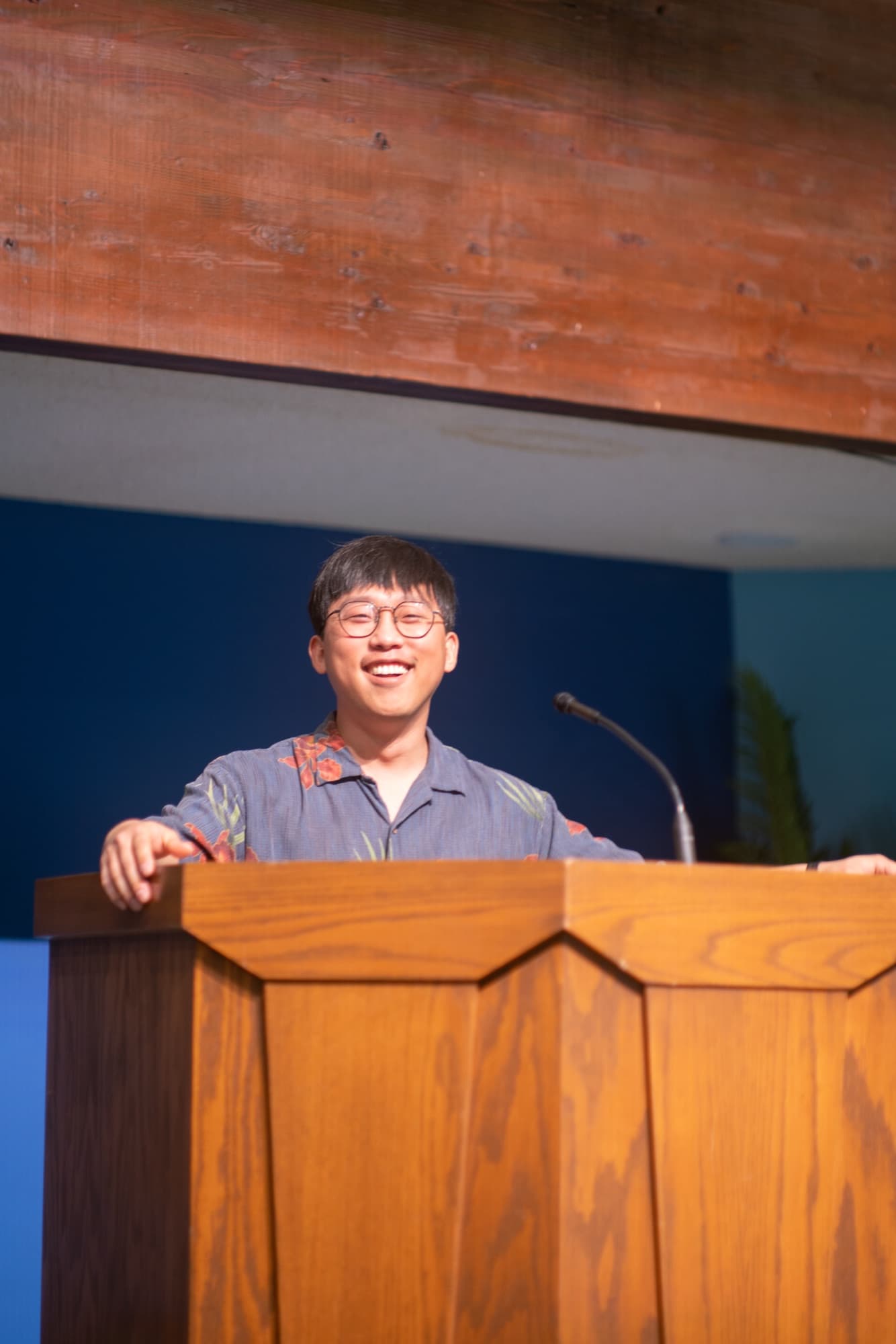 A preacher smiling behind the pulpit